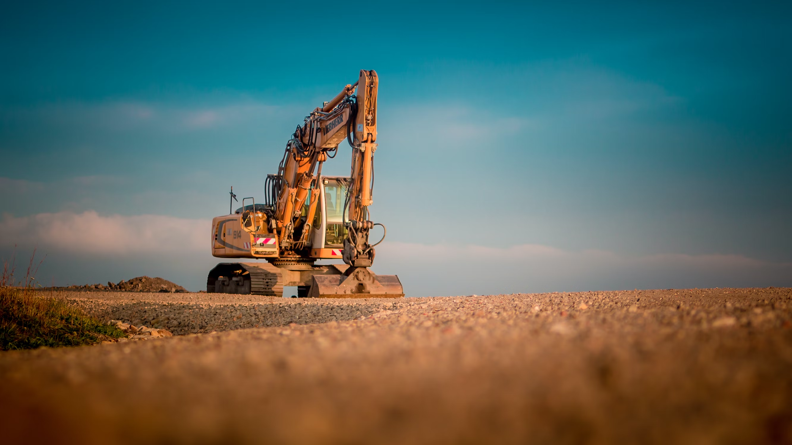 About us page, bulldozer on construction site at sunset